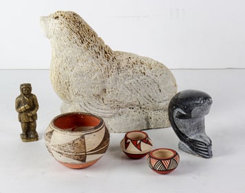A Native American lot including a soapstone figure of a seal, two miniature Acoma pots (one signed