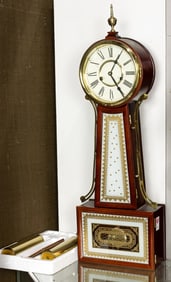 An American style brass mounted cherry and eglomise banjo clock
