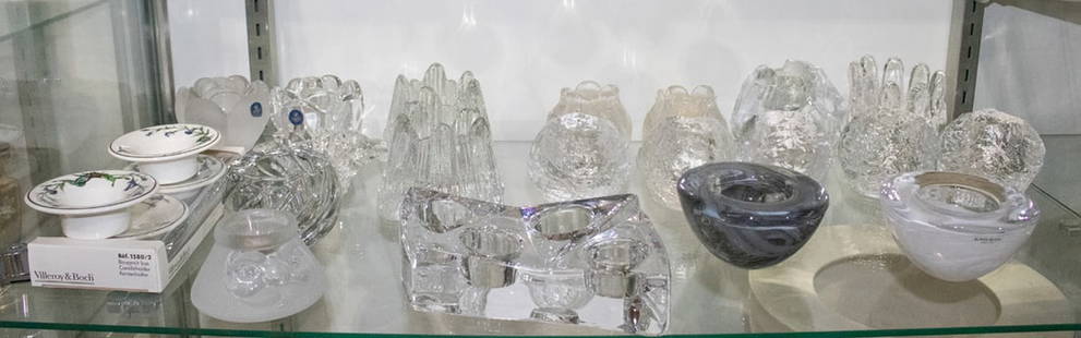 A group of twenty-three Kosta Boda and other glass votives: A group of twenty-three Kosta Boda and other glass votives, comprising group of Kosta Boda including (1) Atoll in white; (1) Atoll in grey; (5) Snowball; (1) The Rock; (1) Sunflower; (2) Rosebud; and