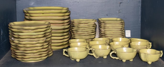 A green glazed pottery dinner service for twelve