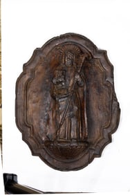 A Continental style carved relief plaque of a saint