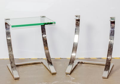 A pair of cantilevered glass side tables