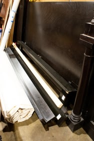 A Modern ebonized wood bedstead