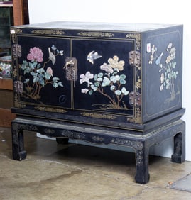 A Chinese black lacquered chest and stand