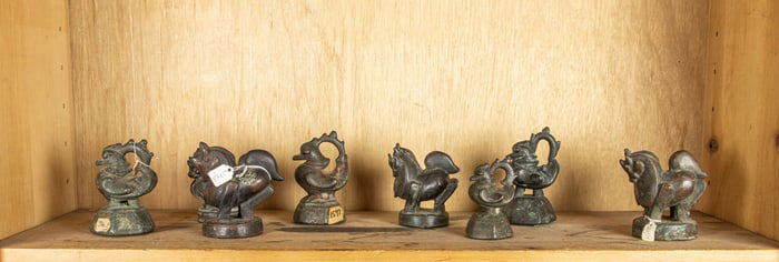 A shelf of Burmese bronze weights