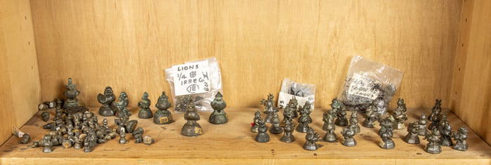 A shelf of Burmese bronze weights
