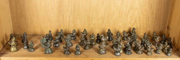 A shelf of Burmese bronze weights