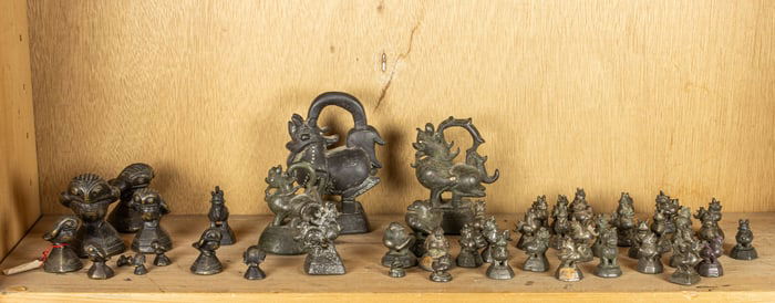 A shelf of Burmese bronze weights