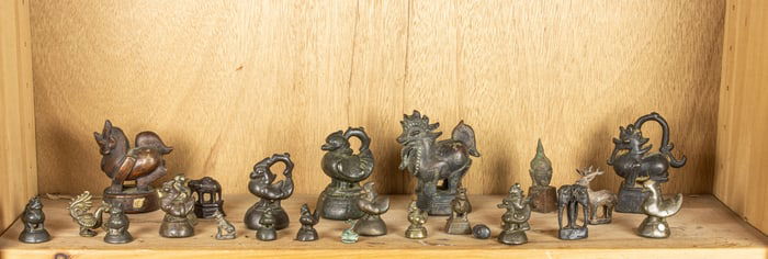 A shelf of Burmese bronze weights