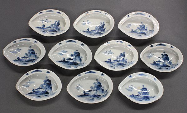 Ten Small Japanese Blue-and white Imari Dishes, Meiji: (lot of 10) Japanese blue-and-white small Imari porcelain dishes, Meiji period, of abalone shape, decorated with a figure in landscape scene, 3.63" l