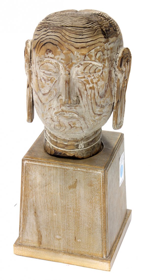 Japanese Carved Wood Head of a Buddhist Figure: Japanese wooden carved head of Jizo, with downcast eyes, a straight long nose above a small mouth (cracked), with wood stand, head: 7.5"h; Provenance: Deaccessioned from the Art, Design & Architecture