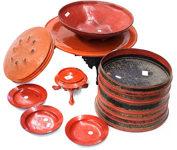 Seven Southeast Asian Lacquer Items: (lot of 7) Southeast Asian and Burmese lacquered items, consisting of three red lacquered plates, one footed stand, one two tier woven cylindrical food basket (lacking lid); one large covered containe