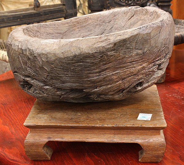 Southeast Asian carvings: (lot of 2) Southeast Asian carvings including a driftwood mortar, 10.5"h x 16"l x 13"d; together with teak stand having shaped supports, 4.25"h x 13.25"l x
