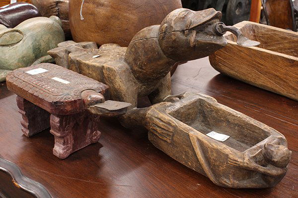 Thai figural carved wood coconut graters: (lot of 2) Thai figural carved wood coconut graters including a zoomorphic form with receiving bowl, and a tortoise form, largest: 31"l