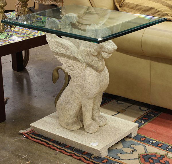 Egyptian Revival style occasional tables: (lot of 3) Pair of Moderne occasional tables, each having a plate glass top above a composition stylized winged lion support executed in the Egyptian Revival taste, and rising on a footed rectangular
