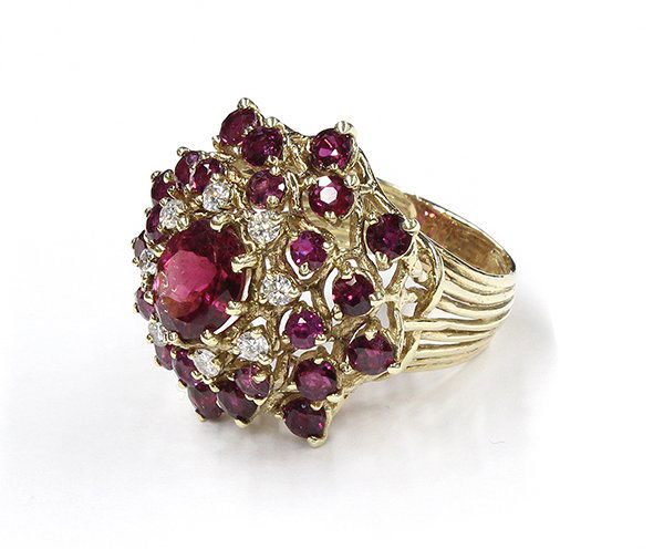 Lady’s pink tourmaline ruby diamond cluster yellow gold: Lady's pink tourmaline, ruby and diamond cluster ring, center set with a 2.00 carat oval cut pink tourmaline, surrounded by rubies weighing approximately 3.84 carats total; mounted in fourteen karat y