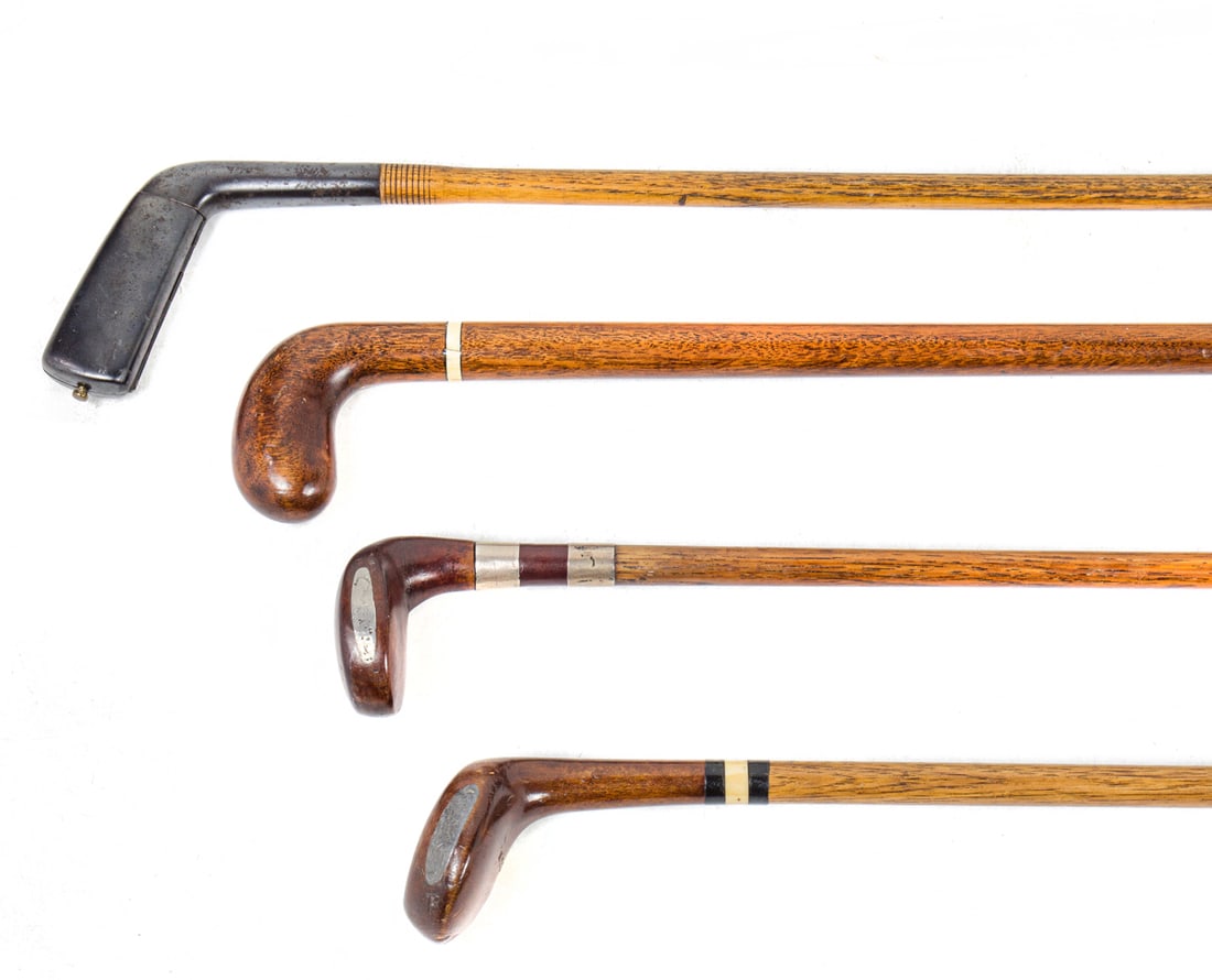 Four novelty golf club 'Sunday' walking canes: Four novelty golf club 'Sunday' walking canes, late 19th/early 20th century, including one with silver monogram collar dated 1908; two inlaid with bone dominos and one with snuff box, between 34"h and