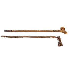 Two Folk Art carved walking canes with grotesque faces