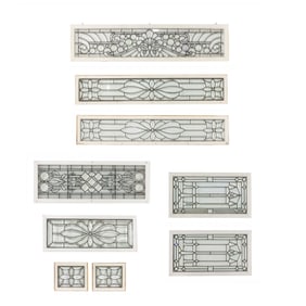 A group of nine leaded beveled glass windows in white painted frames