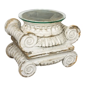 A side table composed of two stacked Doric architectrual capitals