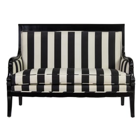 An Empire style ebonized settee with black and white striped upholstery