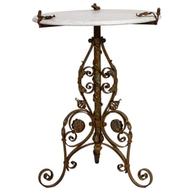 A European wrought iron and marble bistro table