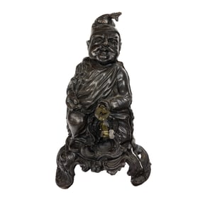 A cast iron comedic figure of a seated man