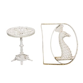 A painted cast iron architectural element of a peacock and a cast iron table