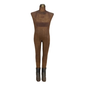 A full size child's display mannequin with cast iron boots