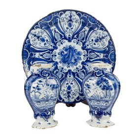 A Dutch Delft blue and white plate and pair of vases