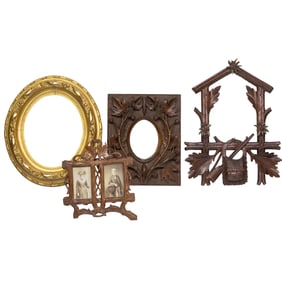Three Black Forest carved wood frames