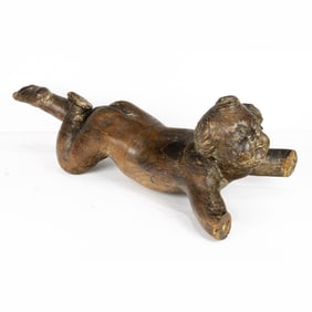 A Continental Baroque carved putto depicted as if in flight