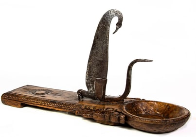 An Indian carved hardwood coconut cutter with iron blade