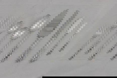 A Wallace Rosepoint sterling silver flatware service: A Wallace Rosepoint sterling silver flatware service: (12) dinner forks 9"l; (12) dinner knives with stainless blades 9.75"l; (12) salad forks 6.25"l; (22) teaspoons; (11) sold silver butter