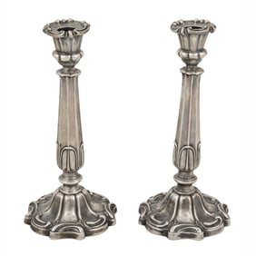 A pair of Victorian sterling silver weighted candlesticks with armorial