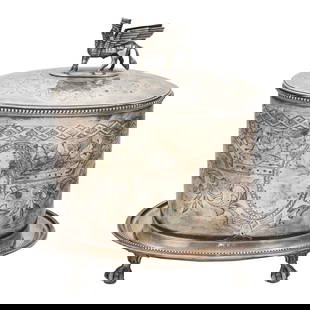 An English silver plated biscuit barrel in the Assurian Revival taste, Hukin & Heath, late 19th: An English silver plated biscuit barrel in the Assurian Revival taste, Hukin & Heath, late 19th century, the finial in the form of Lamassu, 8"h x 8.25"w x 6.5"d