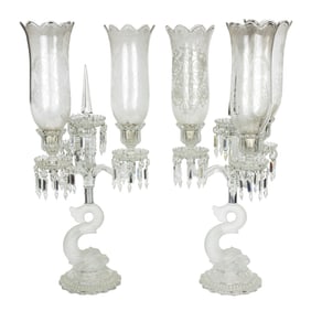 A pair of Baccarat dolphin three light candelabra