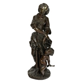 A Continental patinated bronze figure of a girl and putto allegorical of love