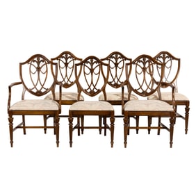 A suite of six hepplewhite style walnut dining chairs