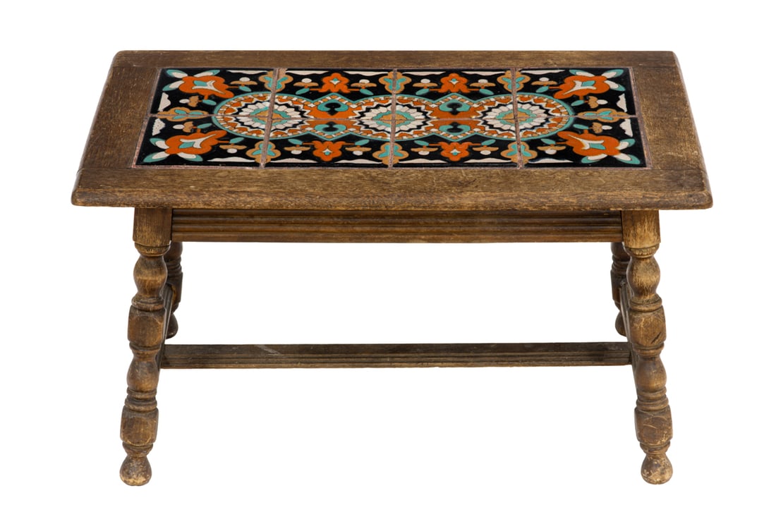 A Spanish Revival Taylor tile top table, circa 1920: A Spanish Revival Taylor tile top table, circa 1920, the top with eight tiles, and rising on block and turned legs, 17.5"h x 23.5"w x 17.5"d