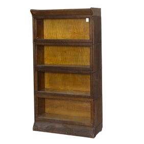 An Arts and Crafts oak four stack barrister bookcase