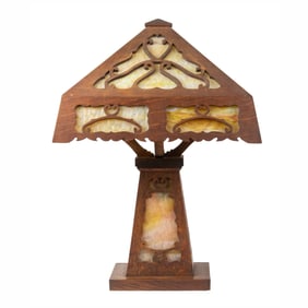 An Arts & Crafts caramel slag glass and oak table lamp