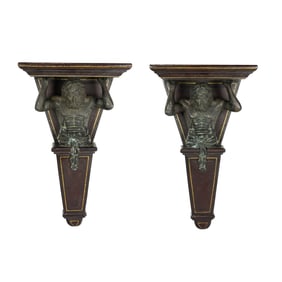 A pair of Maitland-Smith patinated bronze and tooled leather wrapped figural wall brackets