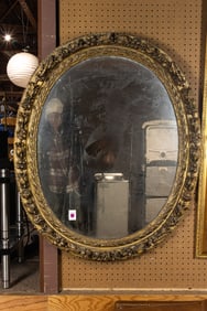 A Neoclassical style oval giltwood mirror