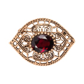 A garnet and 14k gold pendant brooch