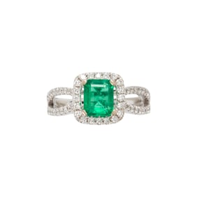 An emerald, diamond and 18k white gold ring