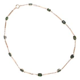 A green sapphire and 10k gold necklace