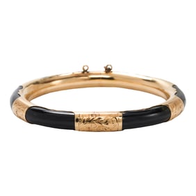 An onyx and 14k gold bangle bracelet