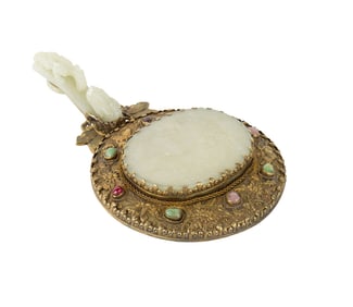A Chinese hand mirror with jade handle