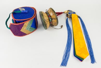 A Tibetan damaru skull drum with silver mount